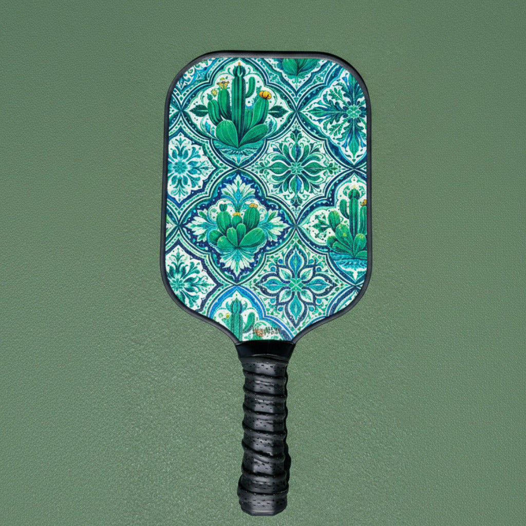 Wooden Beginner friendly Pickleball paddle with a cactus pattern on a green court background