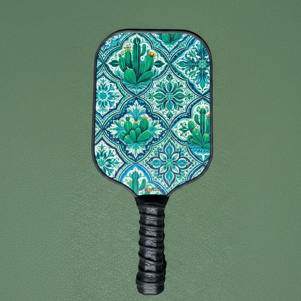 Wooden Beginner friendly Pickleball paddle with a cactus pattern on a green court background